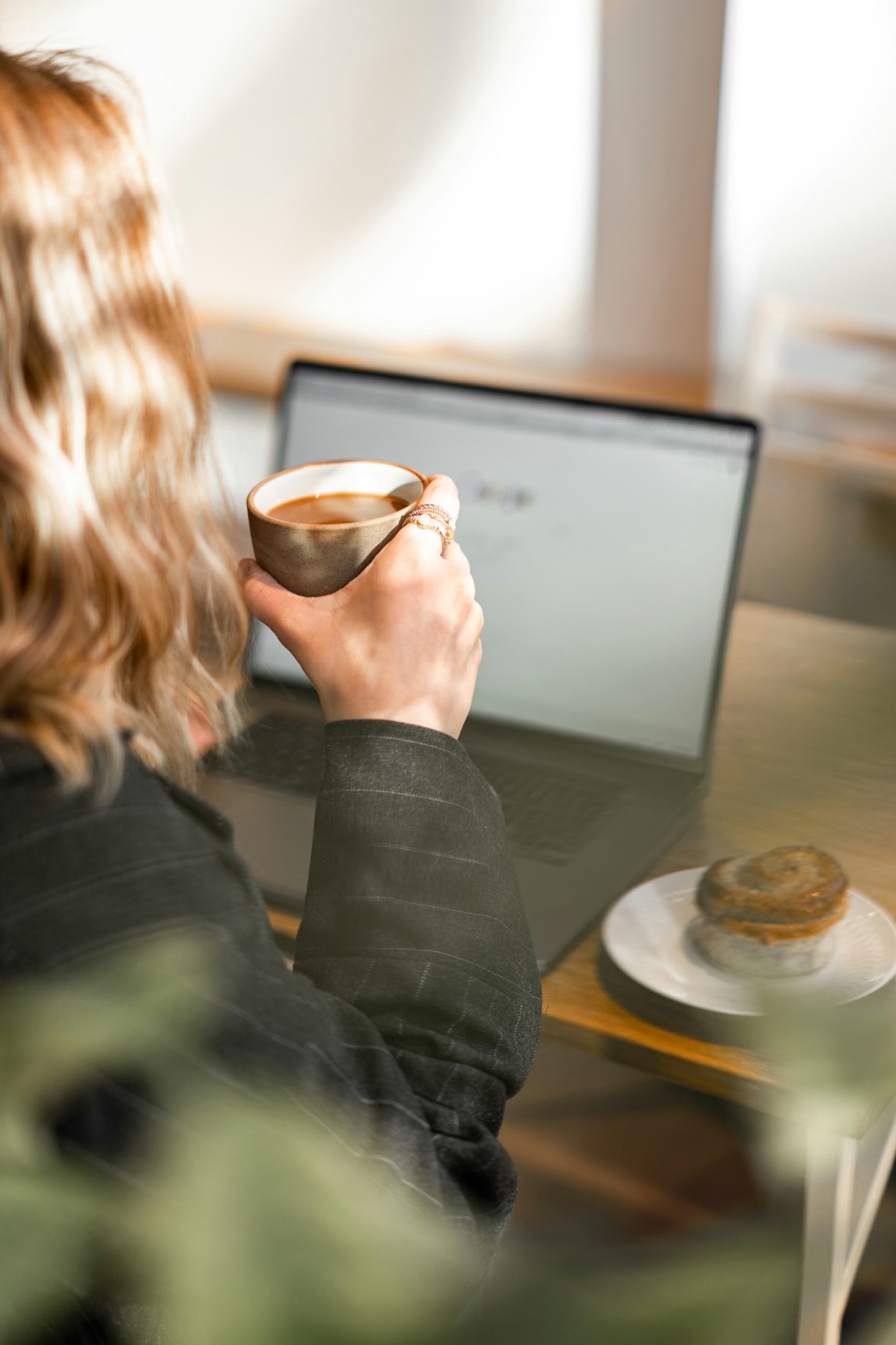Entrepreneur reviewing email strategies over coffee