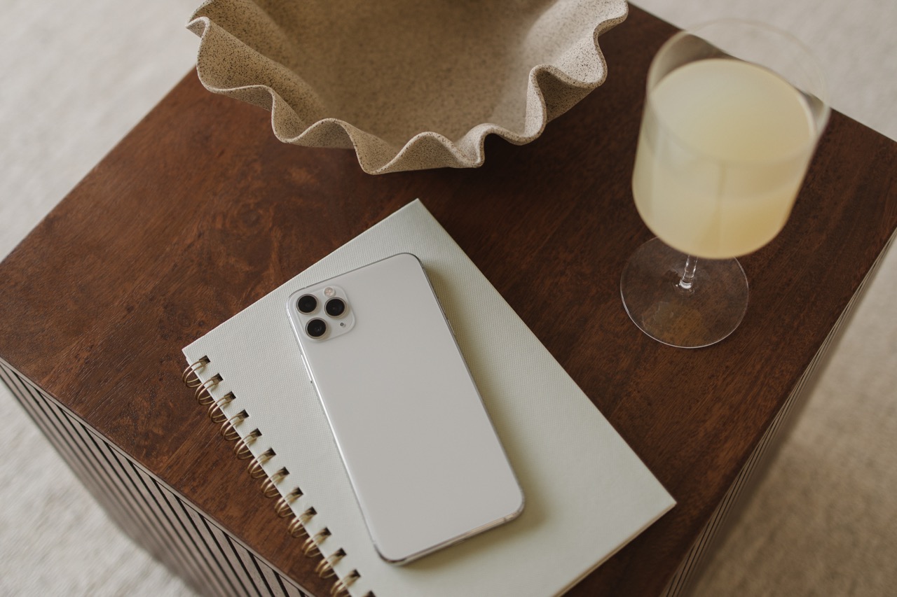 Smartphone on a notepad next to a glass of lemonade, symbolising mobile optimisation for business websites.